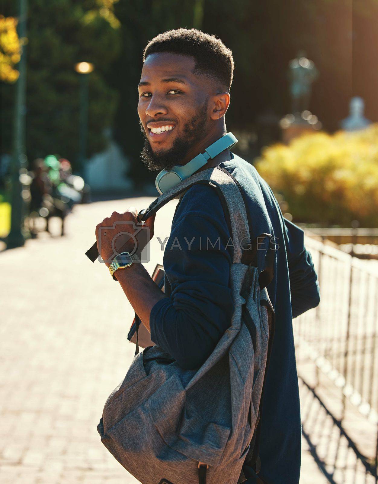 Royalty free image of Black man, student on campus for university in outdoor portrait, education and study with backpack. College, smile and higher education with learning for development and scholarship, going to class. by YuriArcurs
