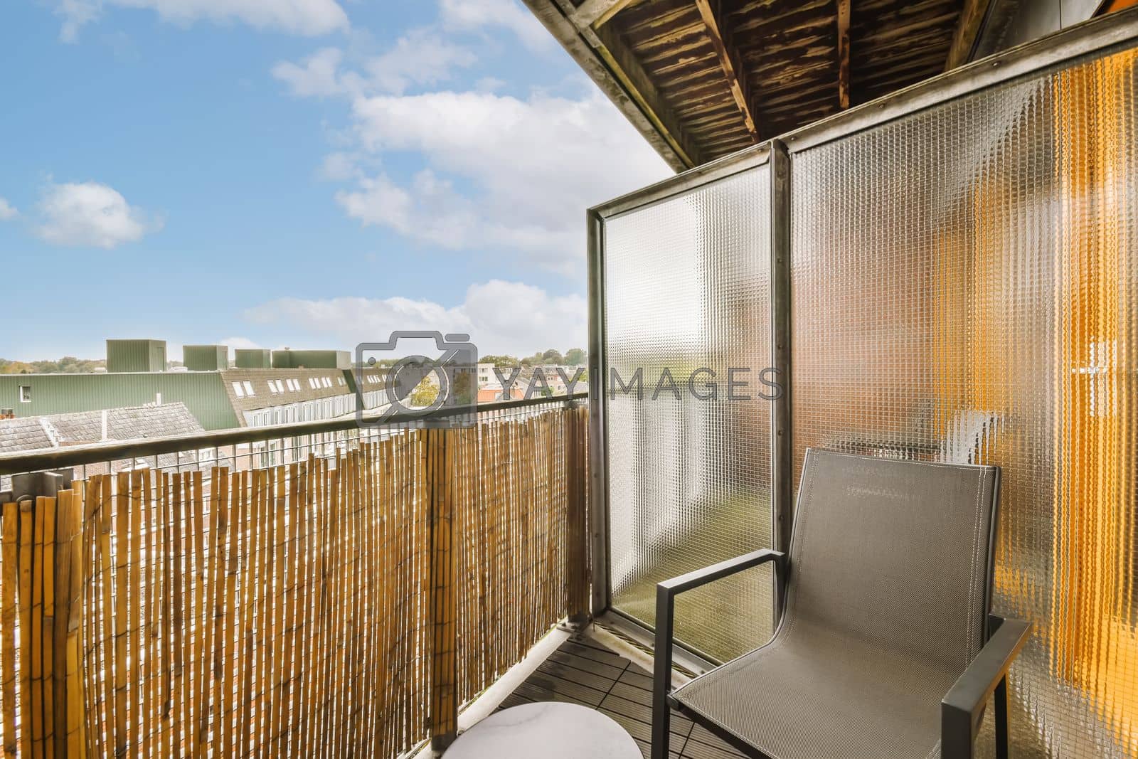 Royalty free image of a balcony with a chair and a fence and a by casamedia