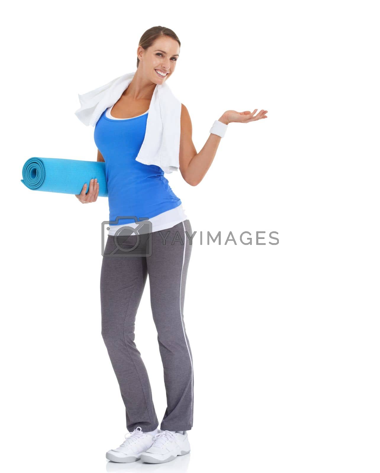 Royalty free image of Heres the answer to your fitness needs...Fit young woman holding a pilates mat with a smile - isolated on white. by YuriArcurs