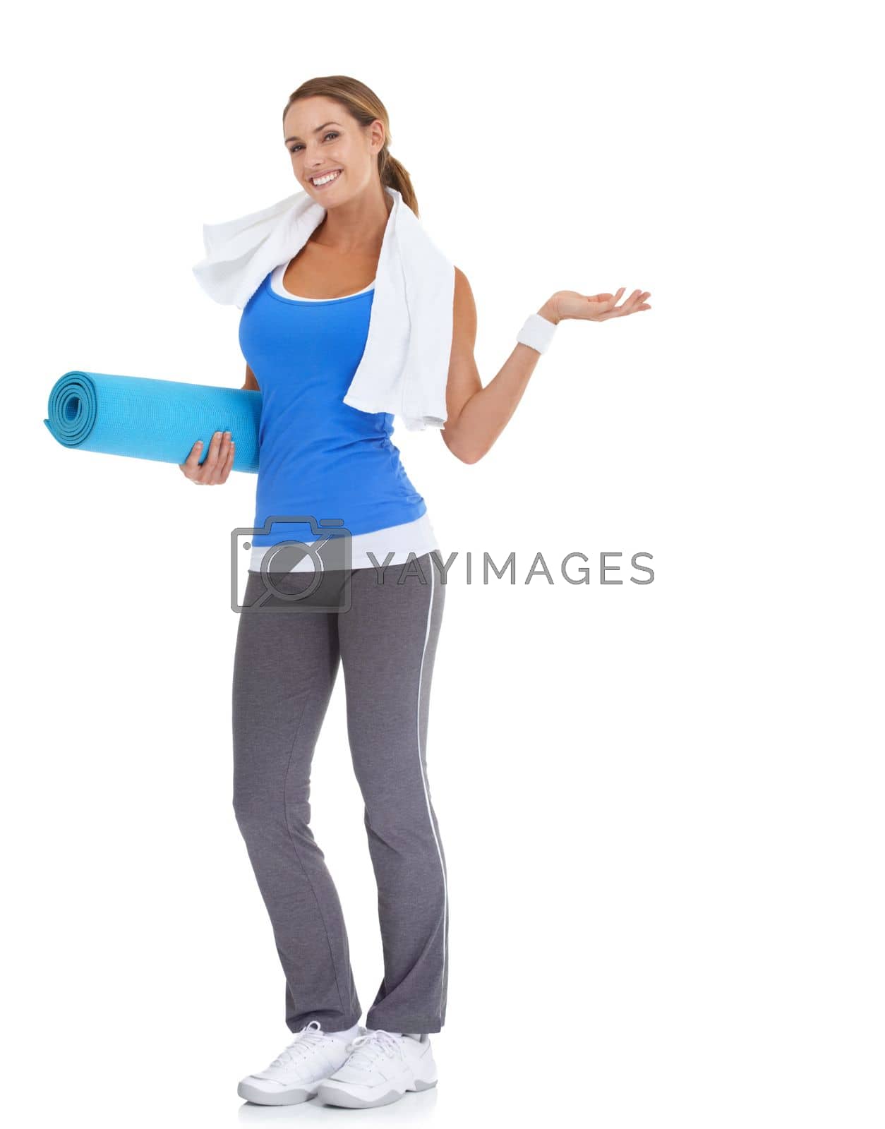 Royalty free image of Suggesting a great fitness option...Fit young woman holding a pilates mat with a smile - isolated on white. by YuriArcurs