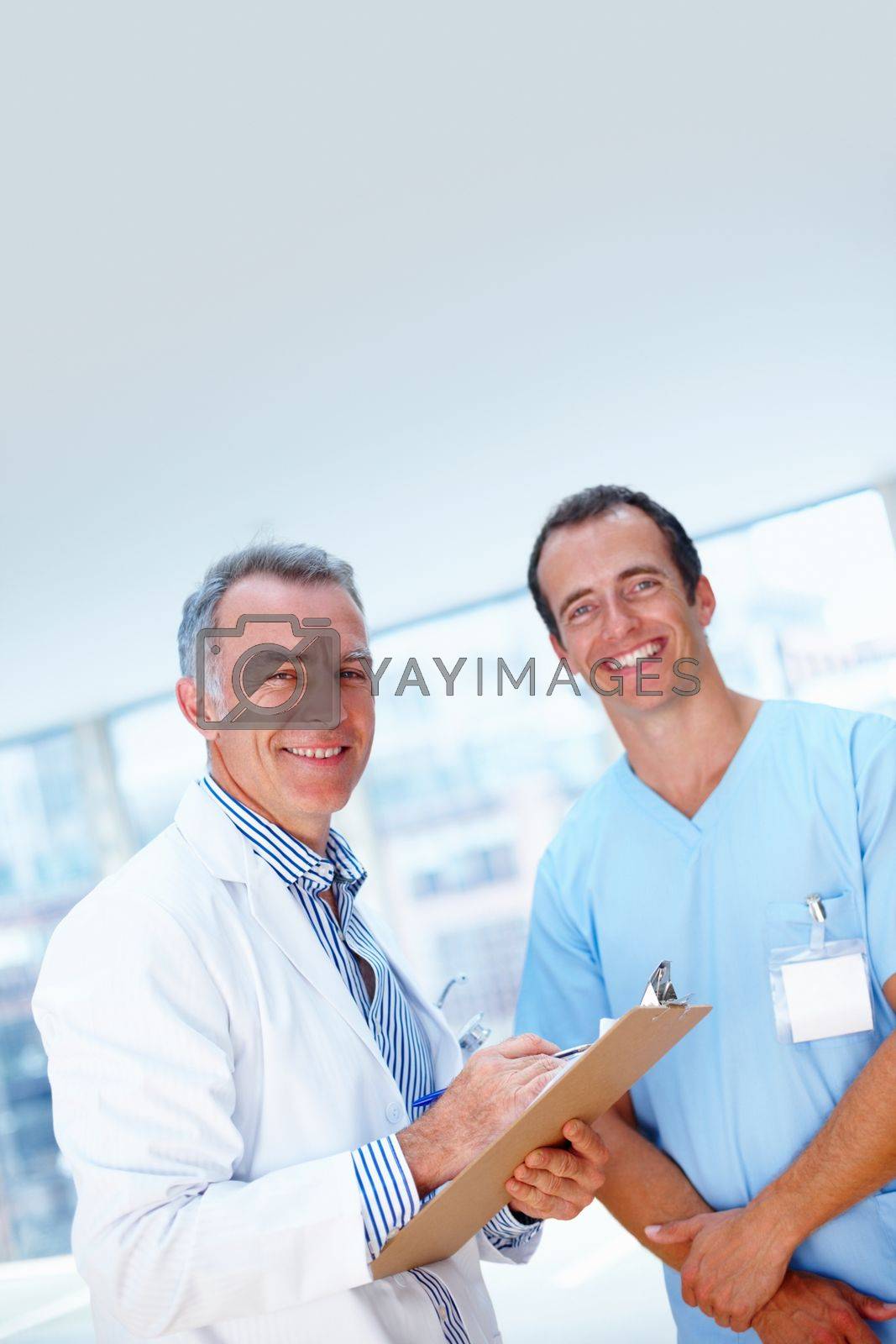 Royalty free image of Happy with diagnosis. Healthcare professionals posing with chart. by YuriArcurs