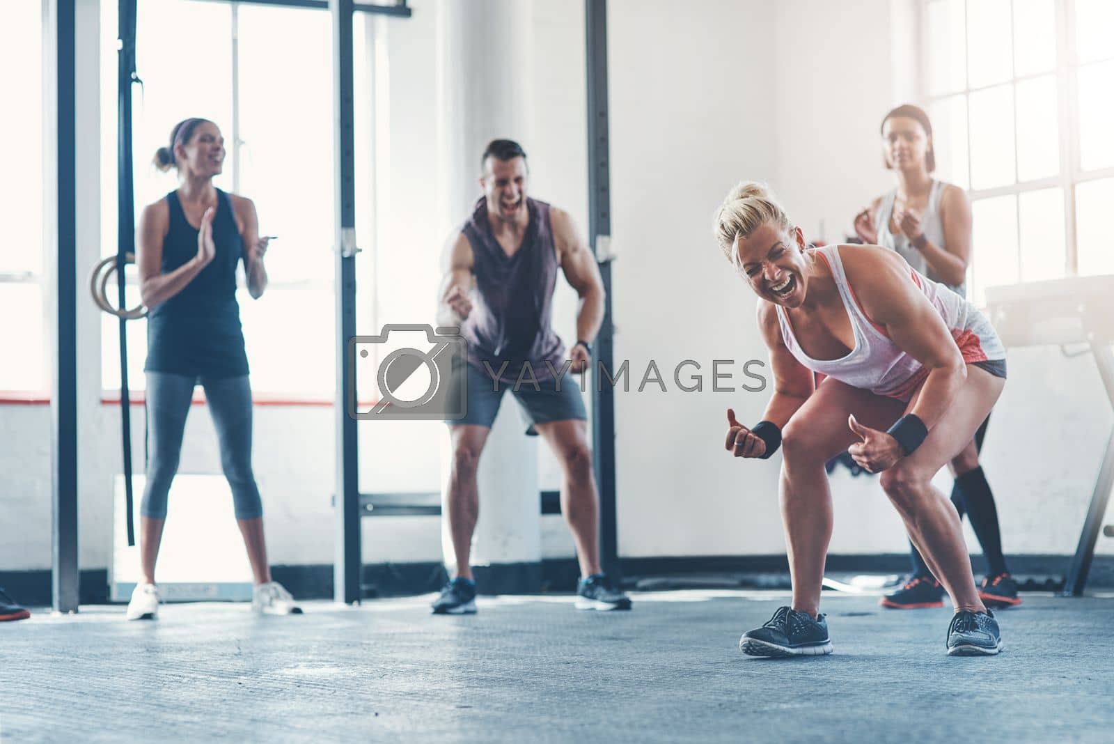 Royalty free image of Celebrate every victory. a fitness group celebrating a victory at the gym. by YuriArcurs