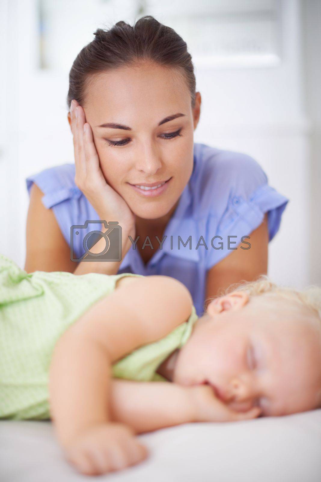 Royalty free image of No love stronger than a mothers. a mother watching over her sleeping child. by YuriArcurs