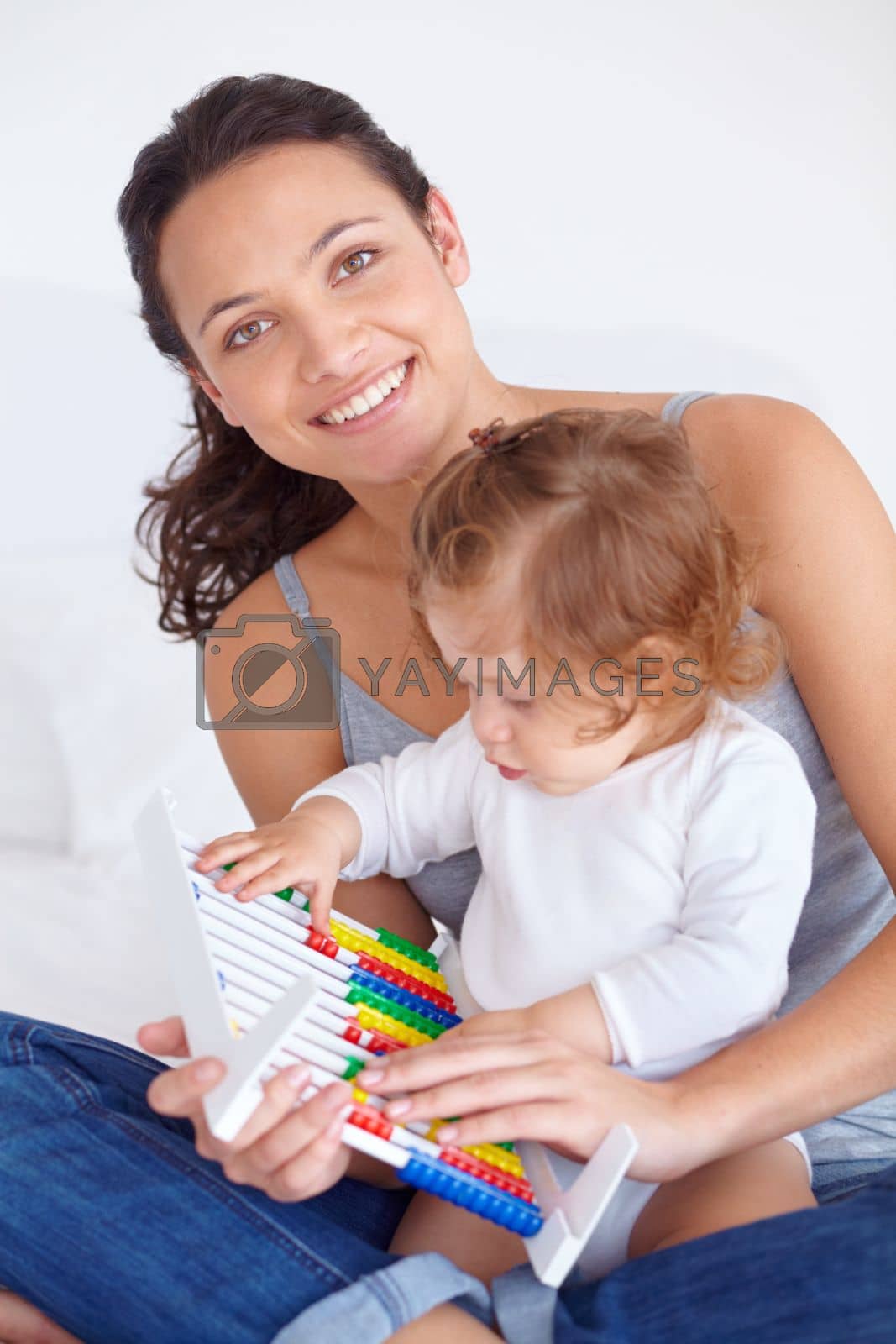 Royalty free image of Helping her daughter learn. A mother showing her baby daughter how an abacus works. by YuriArcurs