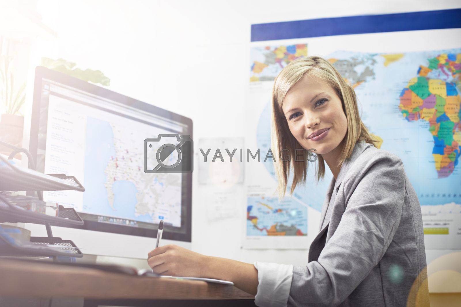 Royalty free image of Let me plan your holiday. Cropped portrait of a young female travel agent working in her office. by YuriArcurs