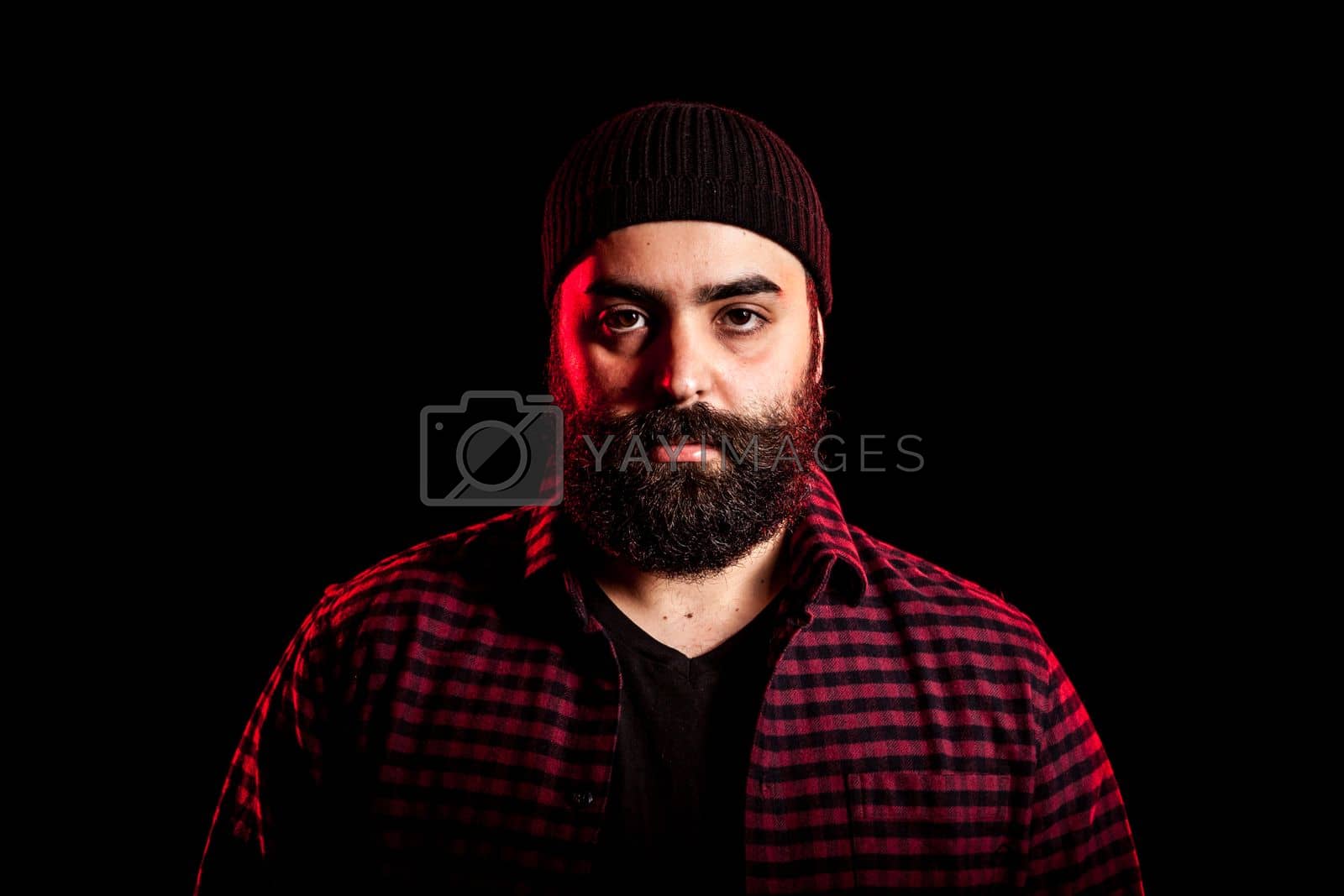 Royalty free image of Bearded hipster in studio portrait by DCStudio