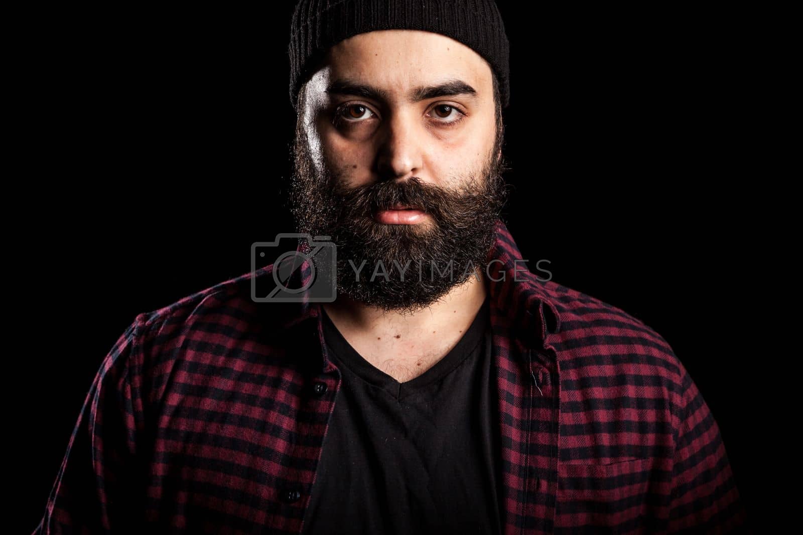 Royalty free image of Angry bearded hipster guy on black background by DCStudio