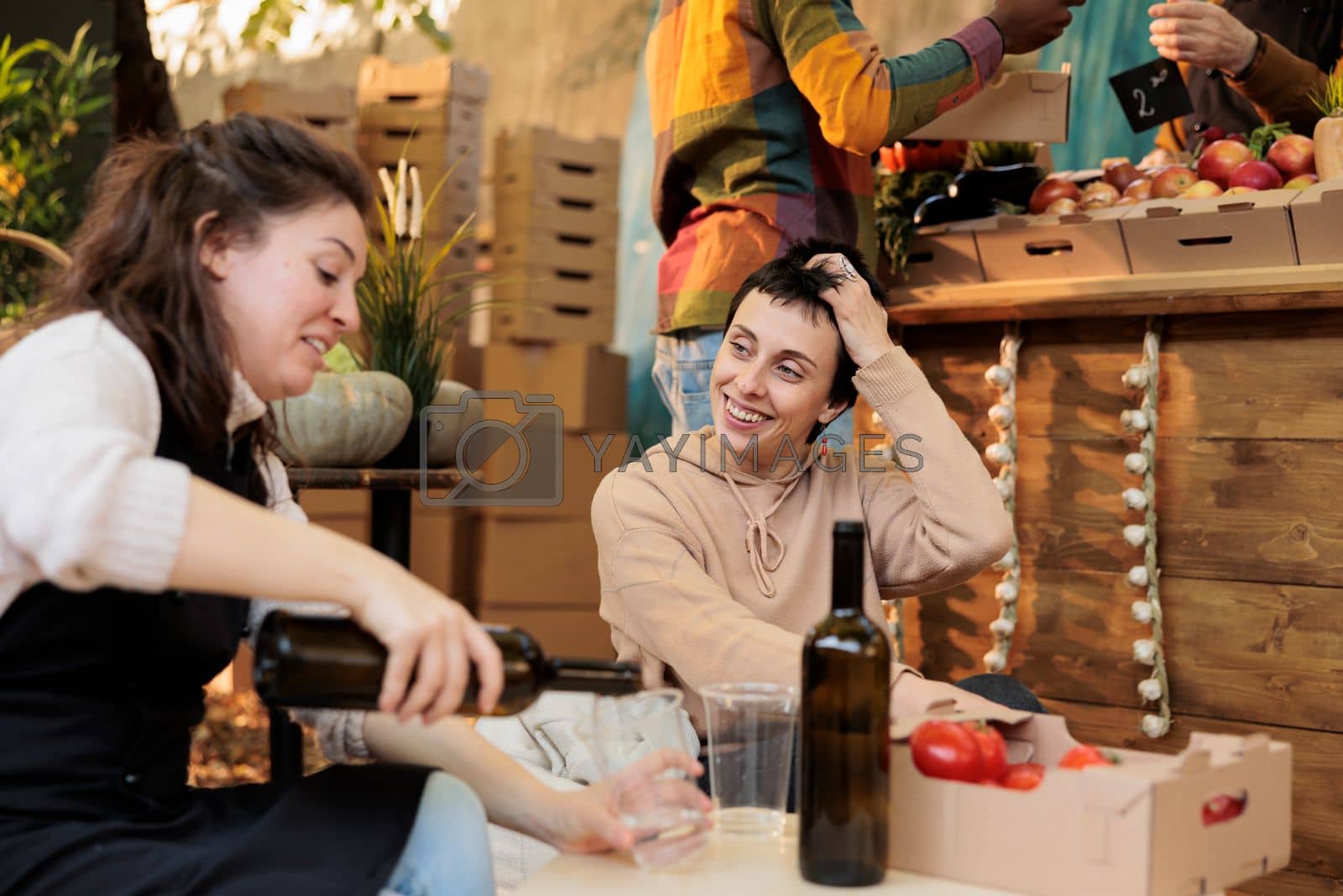 Royalty free image of Two happy persons at food festival tasting homemade wine by DCStudio