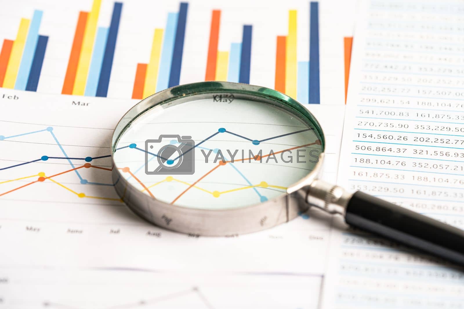 Royalty free image of Magnifying glass on chart graph spreadsheet paper. Financial development, Banking Account, Statistics, economy, Stock exchange trading, Business office company meeting concept. by pamai