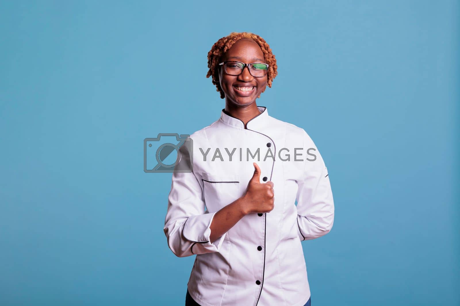 Royalty free image of Curly haired female chef in agreement with peers by DCStudio