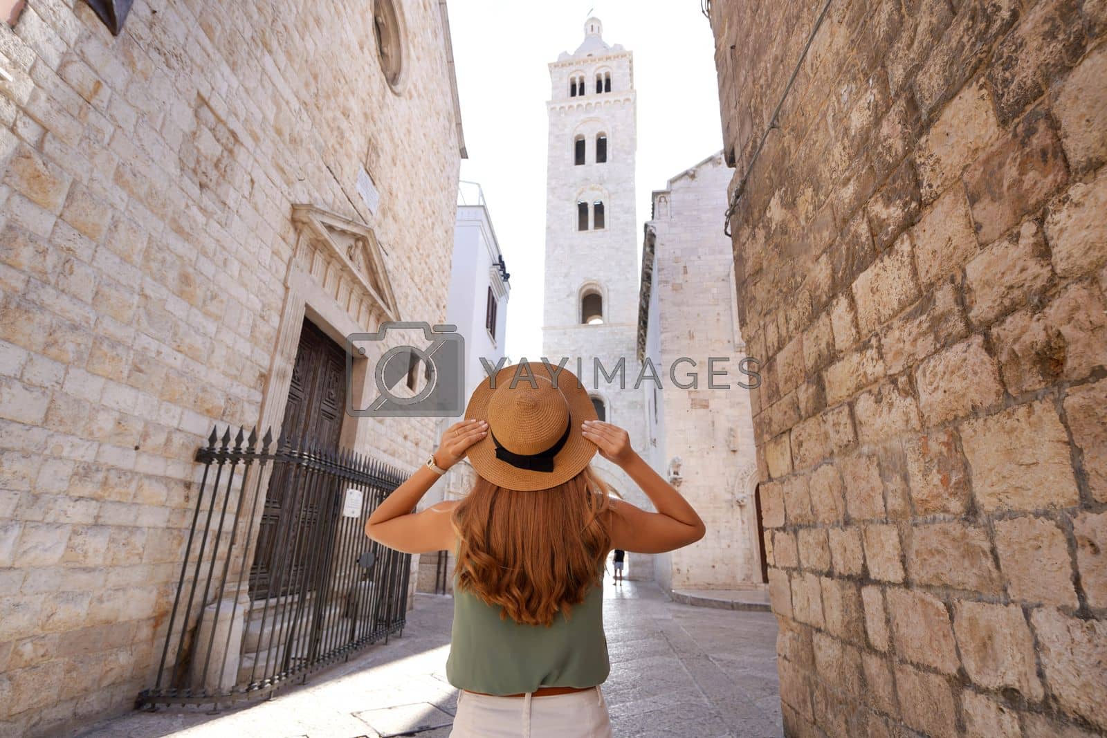 Royalty free image of Back view of tourist girl exploring the historic town of Barletta, Apulia, Italy. Wide angle. by sergio_monti