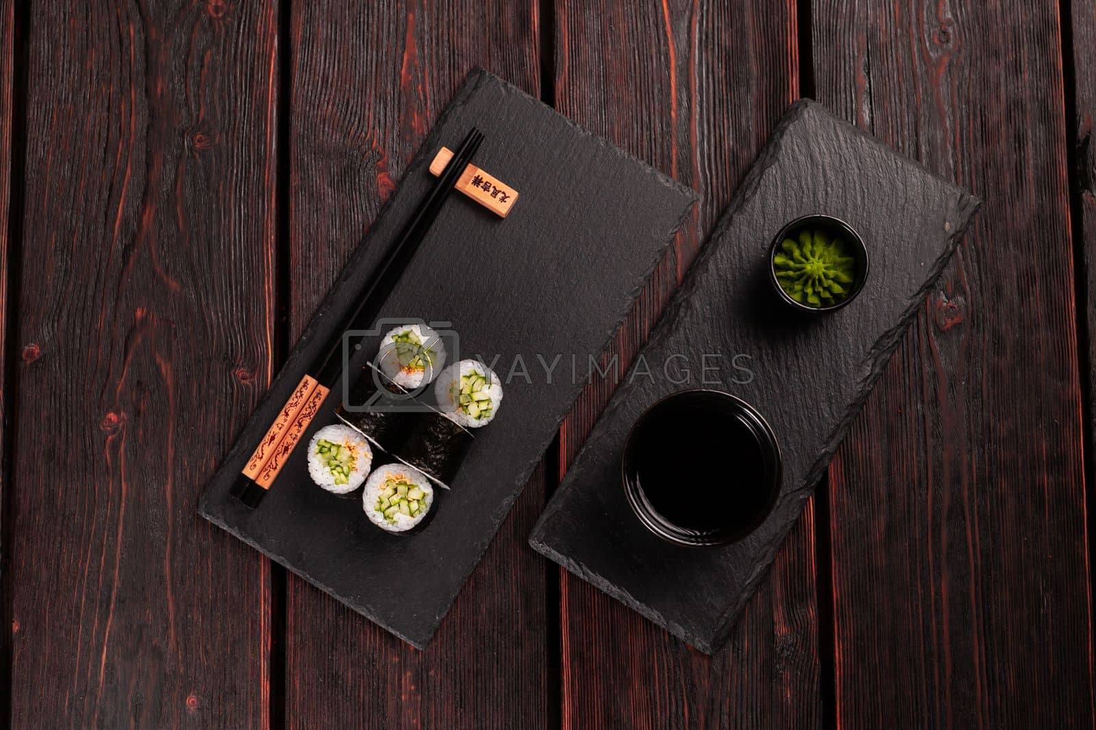 Royalty free image of Maki sushi roll with cucumber and sesame with chopsticks top view. Sushi menu. Japanese food. by Satura86