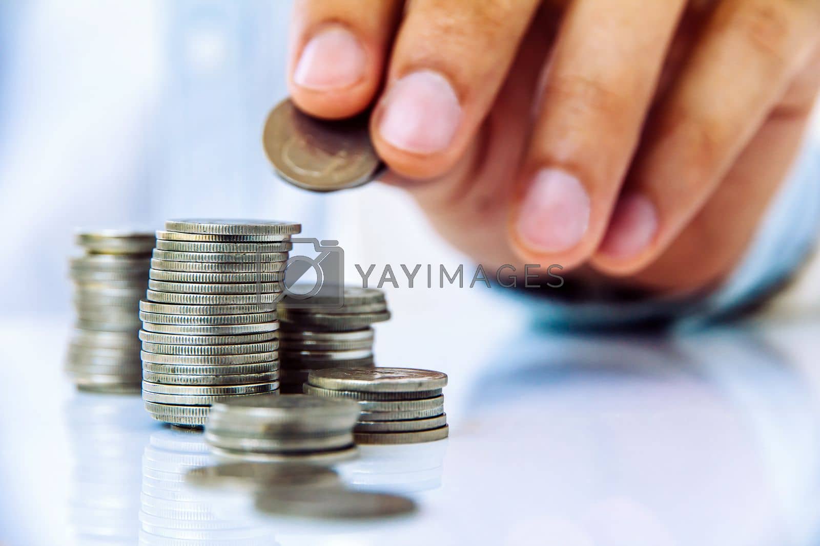 Royalty free image of Hand put coin to stack, investment concept by ponsulak