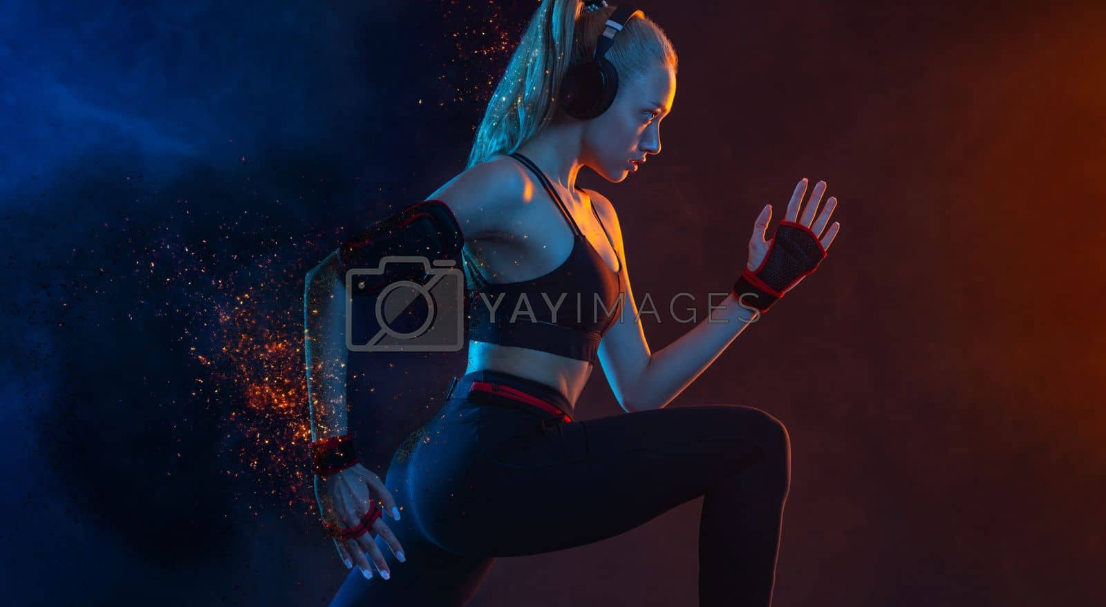 Royalty free image of Sprinter run. Strong athletic woman running on black background wearing in the sportswear. Fitness and sport motivation. Runner concept. by MikeOrlov