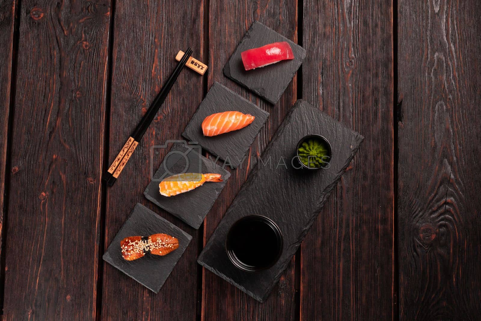 Royalty free image of Delicious Sushi Nigiri on wooden background. Traditional Japanese cuisine by Satura86