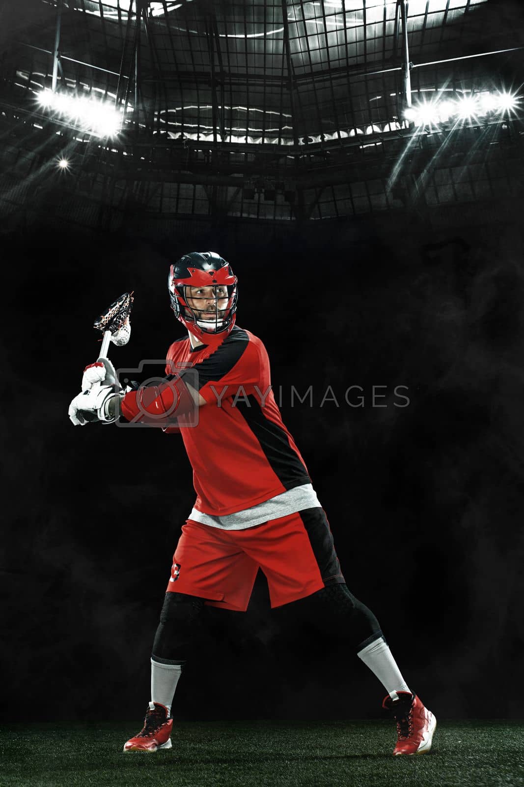 Royalty free image of Lacrosse Player, athlete sportsman in red helmet on grand arena background. Sport and motivation wallpaper. by MikeOrlov