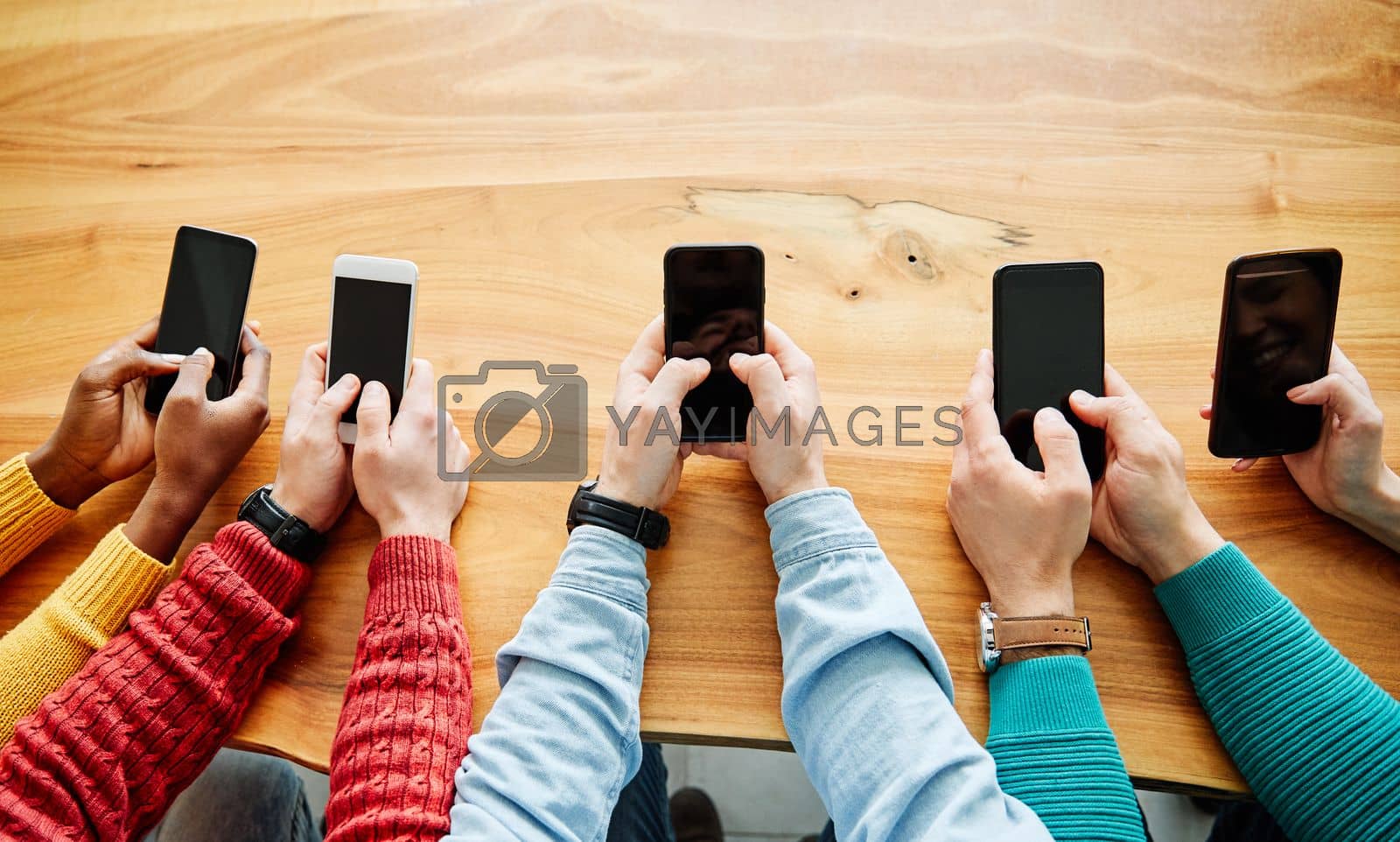 close up shot of a group of young people using their smart phones in synchronicity
