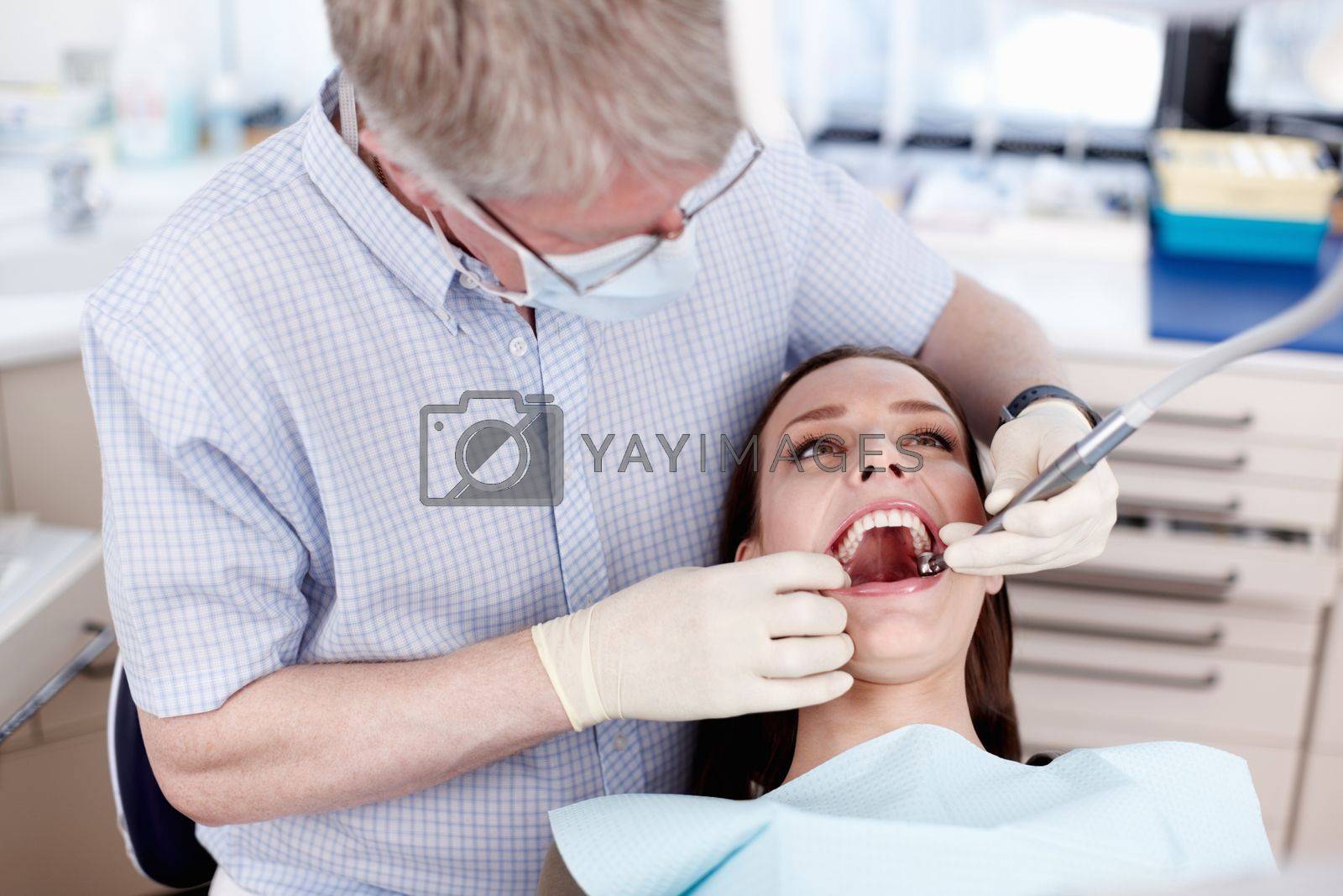 Royalty free image of Dentist and patient. Portrait of female patient with dentist at clinic. by YuriArcurs