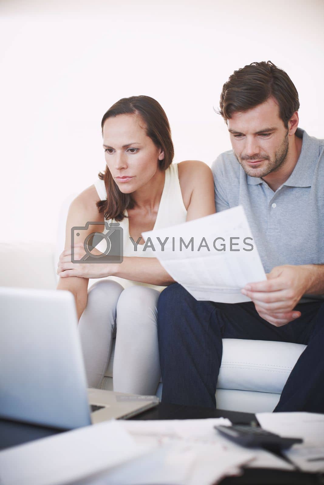 Royalty free image of Drawing up a spreadsheet of income and expenses...A married couple doing some famliy budgeting. by YuriArcurs