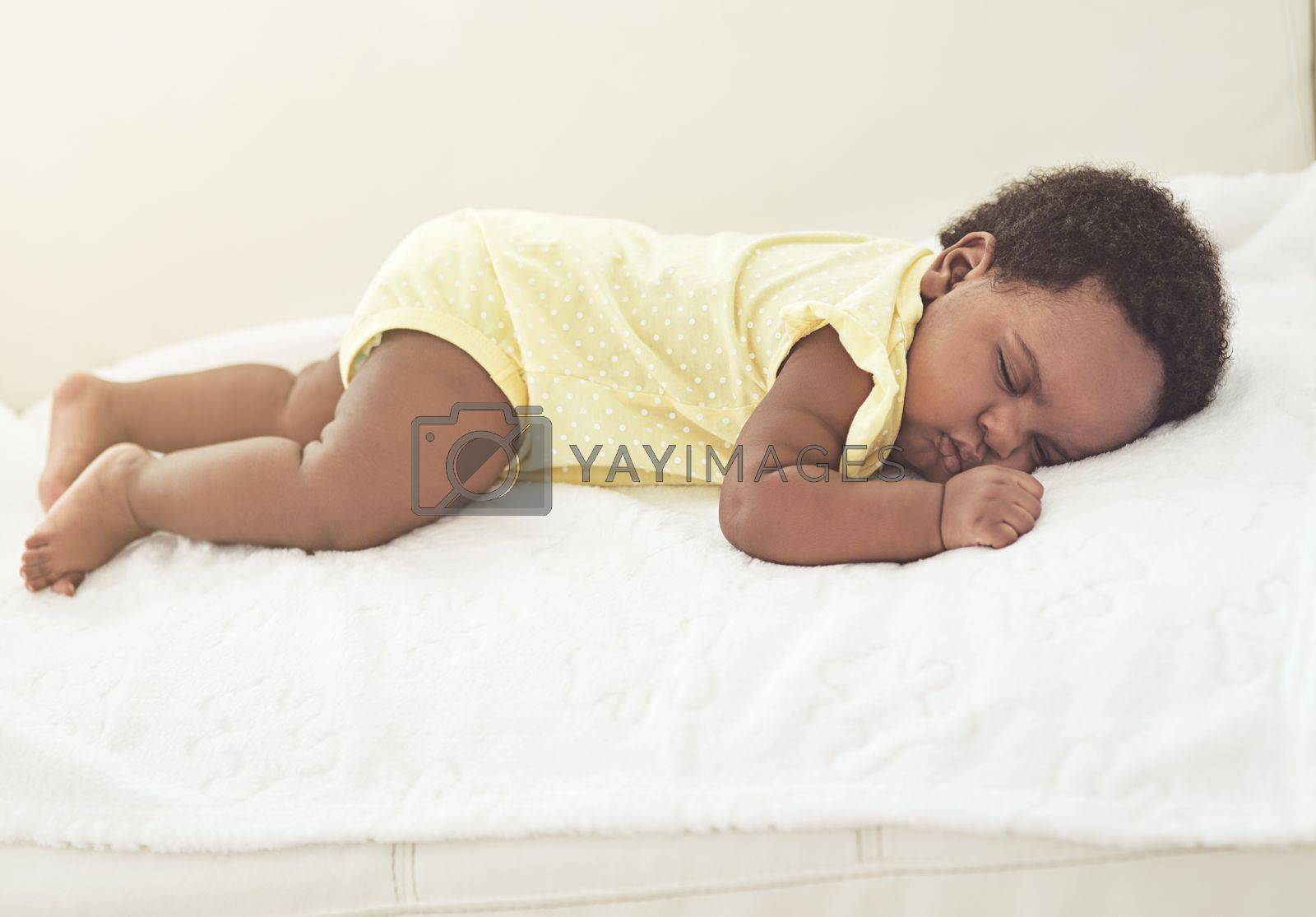 Royalty free image of Babies need lots of rest. a baby girl asleep on a bed at home. by YuriArcurs