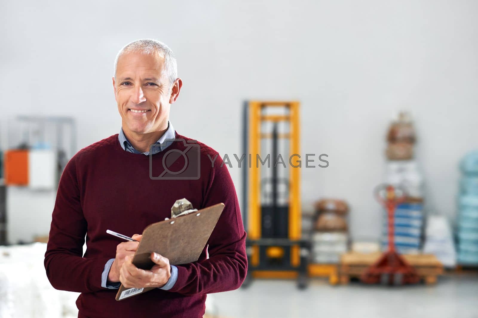 Royalty free image of Making a few notes during his inspection. Portrait of a male foreman standing on the factory floor with a clipboard. by YuriArcurs