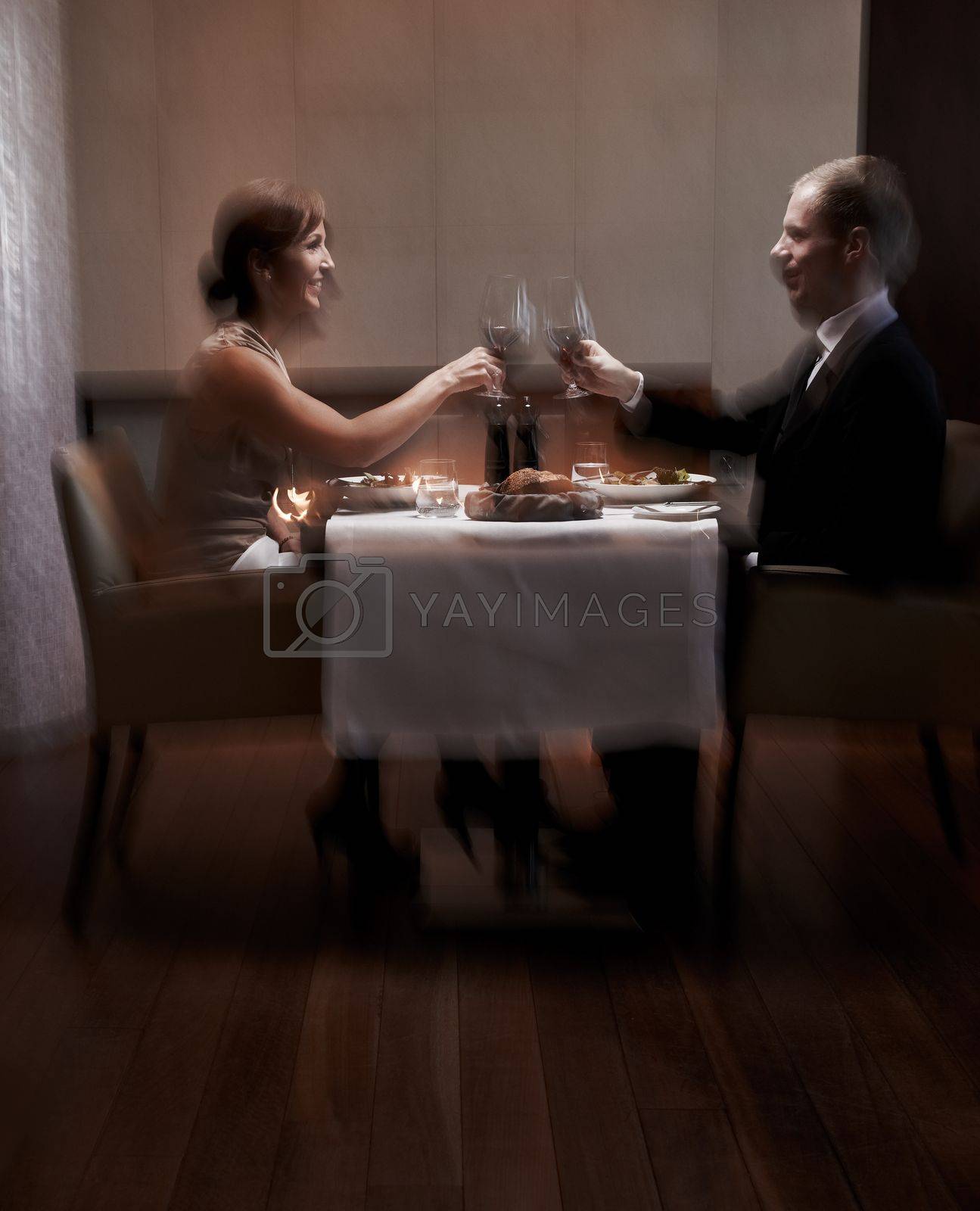 Royalty free image of Love is in the air. a couple having dinner in a restaurant. by YuriArcurs