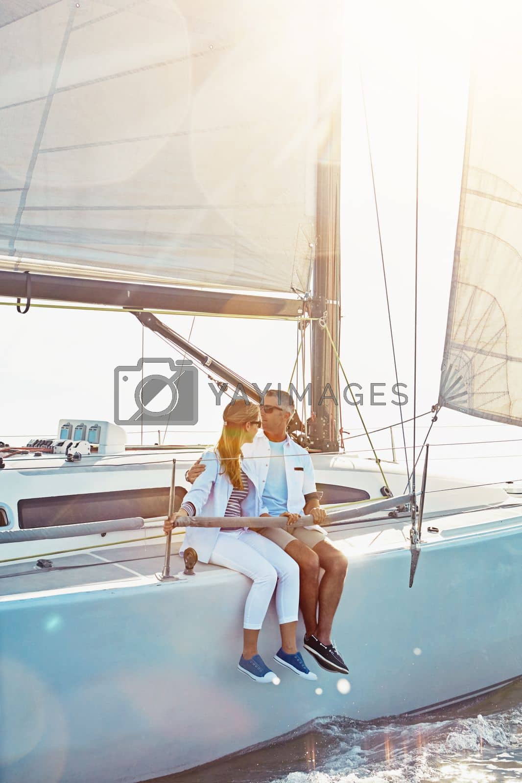 Royalty free image of Relax, travel and luxury with couple on yacht for summer, love and sunset on Rome vacation trip. Adventure, journey and vip with man and woman sailing on boat for ocean, tropical and honeymoon at sea by YuriArcurs