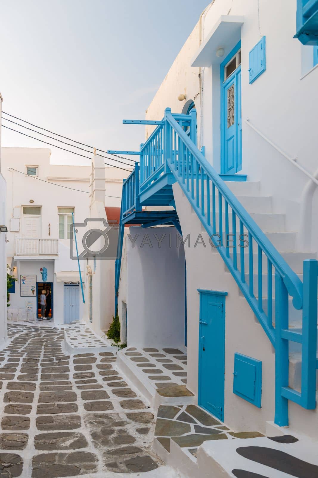 Royalty free image of Tourist at the streets of Mykonos Greek village in Greece, colorful streets of Mikonos village by fokkebok