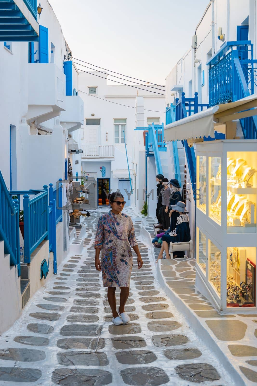 Royalty free image of Tourist at the streets of Mykonos Greek village in Greece, colorful streets of Mikonos village by fokkebok