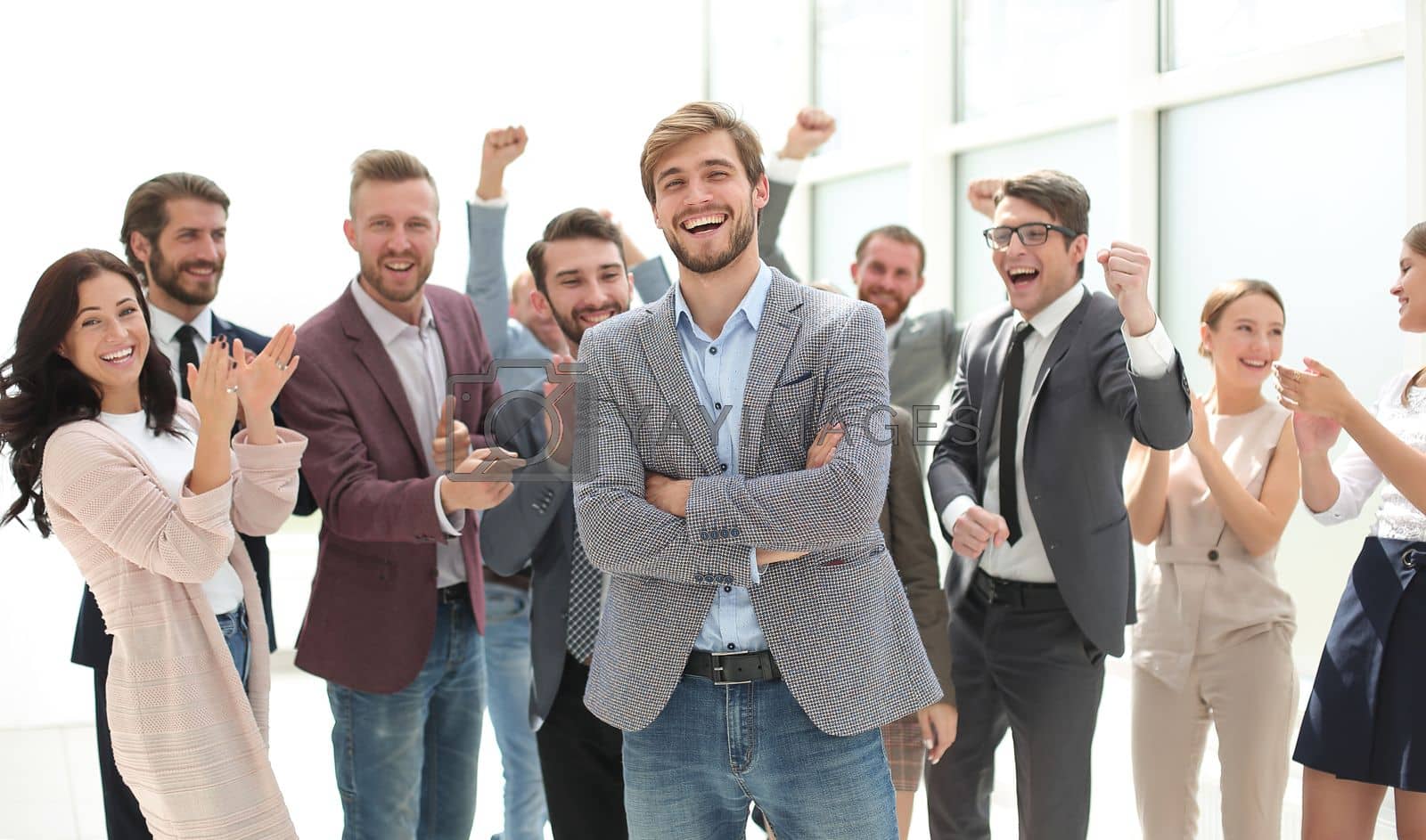 Royalty free image of smiling entrepreneur on the background of jubilant business team by asdf
