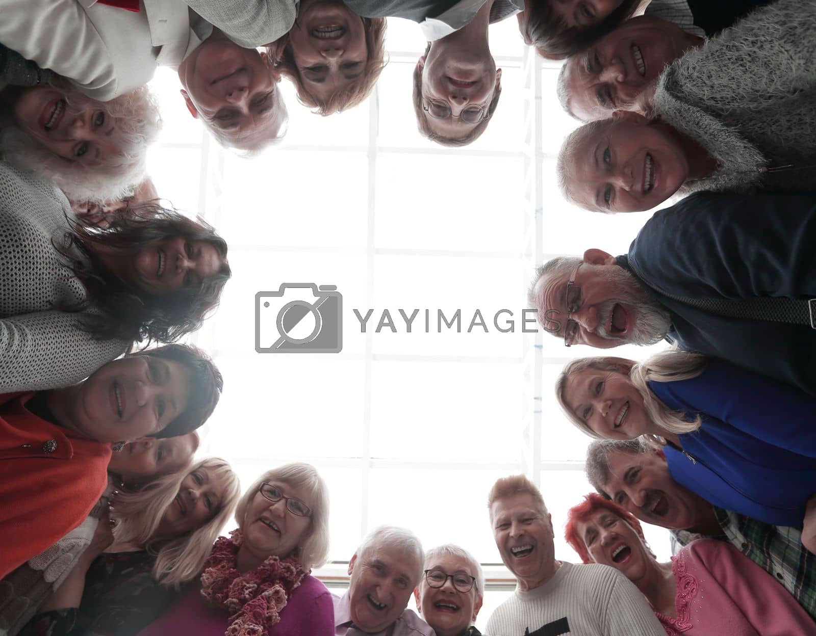 Royalty free image of Happy people looking down at camera by asdf