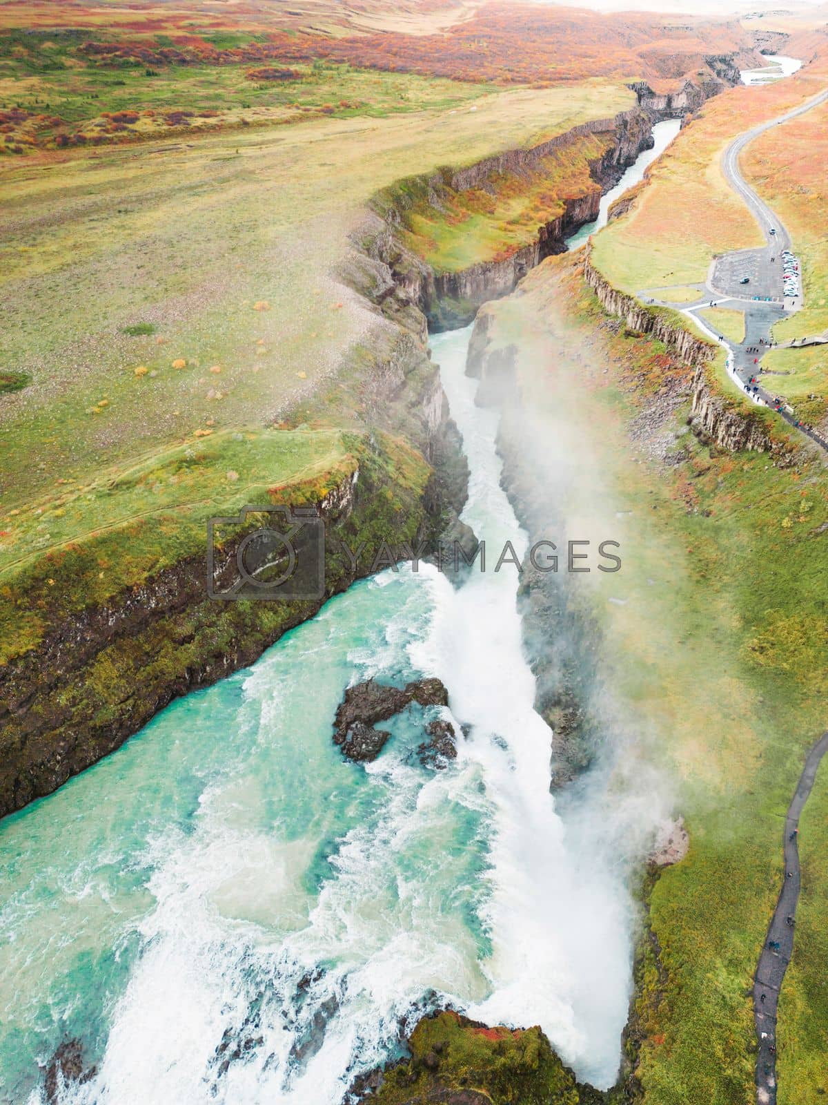 Royalty free image of Vertical photo of Gullfoss waterfall in autumn time of the year, vibrant green hills surrounding the waterfall by VisualProductions