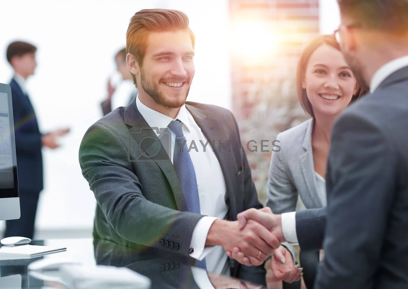 Royalty free image of happy man introducing businesswoman to business partners by asdf