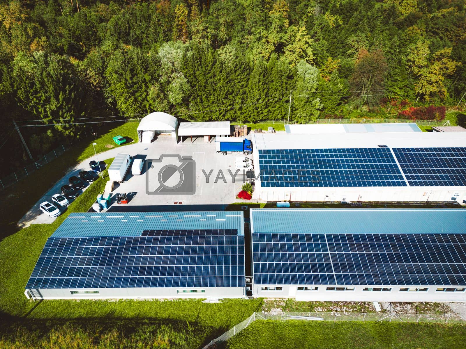 Royalty free image of Solar panels on the rood of industrial buildings on a secluded sunny location by VisualProductions