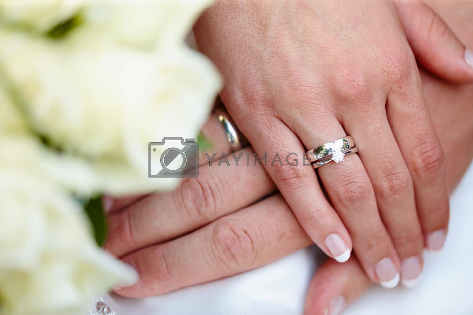 Royalty free image of Its a symbol of commitment. Closeup shot of a couples hands on their wedding day. by YuriArcurs