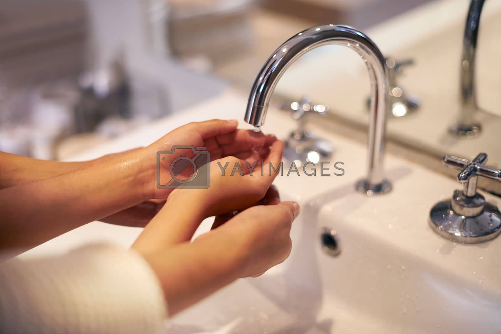 Royalty free image of Washing up before bed. a mother and daughter washing their hands at the bathroom sink. by YuriArcurs