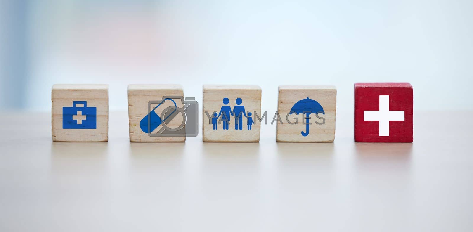 Healthcare, insurance and wooden blocks in studio on an empty gray background for safety or security. Abstract, medicine and health with block toys in a hospital or clinic for medical care.