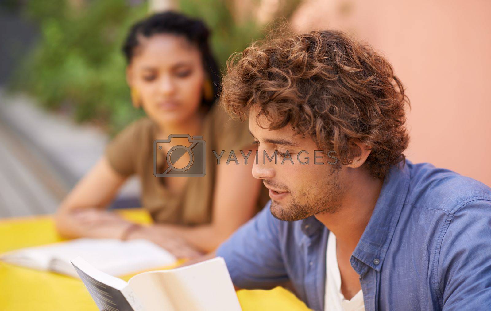 Royalty free image of The fruits of education are sweet. A shot of university students sitting outdoors with reading material. by YuriArcurs