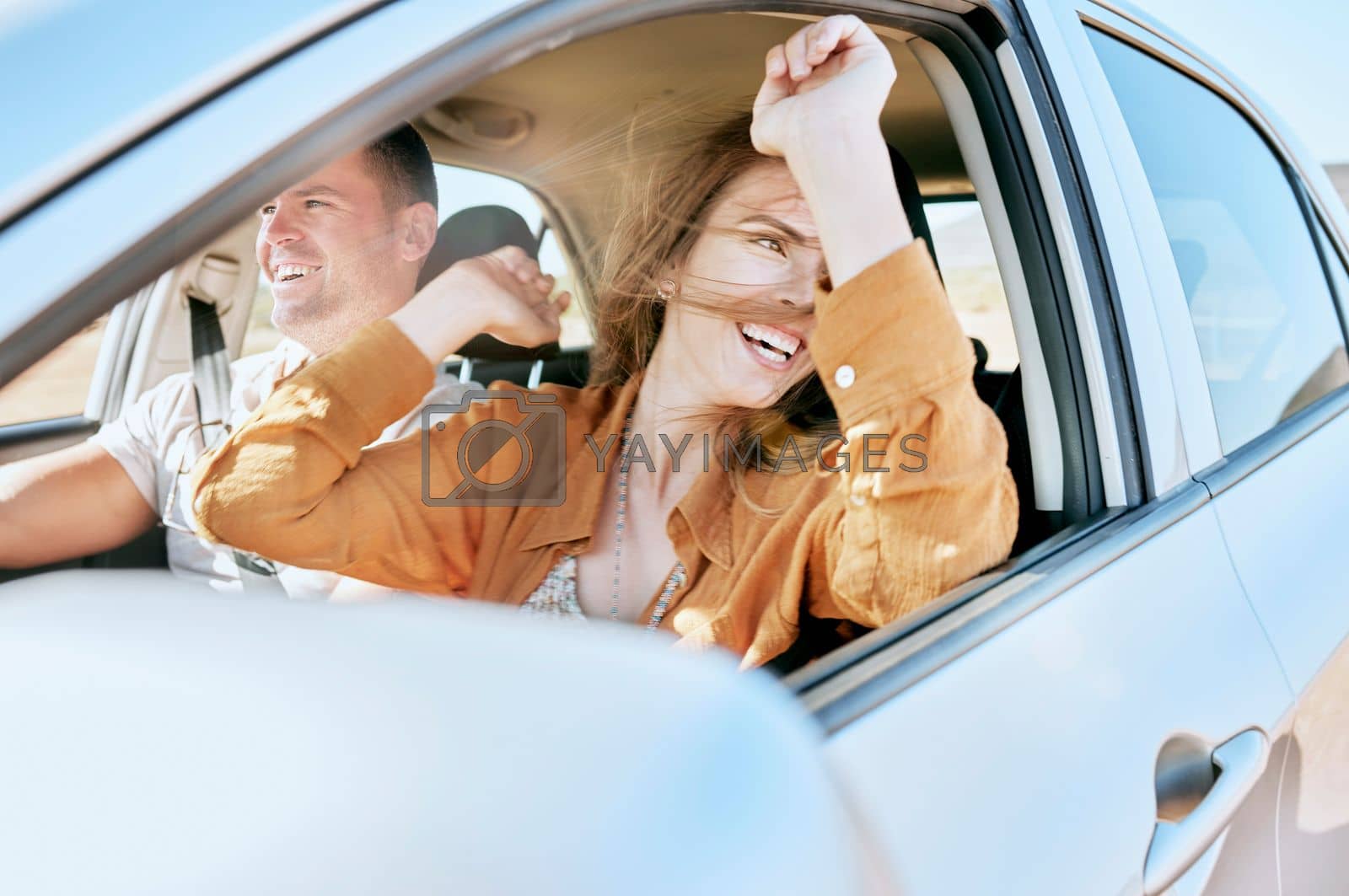Royalty free image of Road trip, travel and couple in a car in nature for freedom, vacation and happiness together. Summer, happy and man with an excited woman with smile on a drive in the countryside with transport by YuriArcurs
