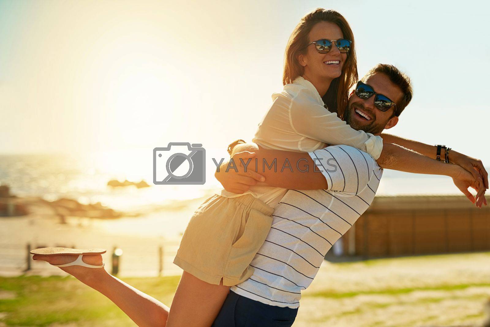 Royalty free image of Romance comes alive in summer. a happy young couple embracing on a summers day outdoors. by YuriArcurs