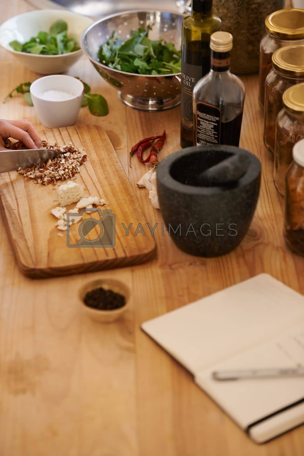 Royalty free image of A healthy selection of ingredients for salad. a woman preparing food in a rustic kitchen. by YuriArcurs