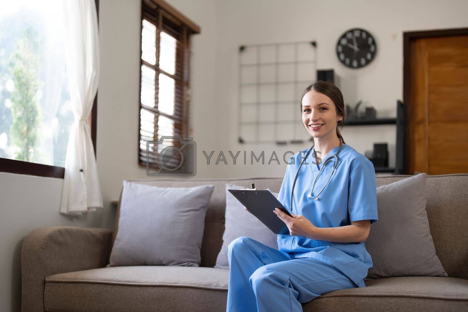 Royalty free image of Portrait of a young Asian nurse or caregiver at home.Concept healthcare, profession, people and medicine by wichayada