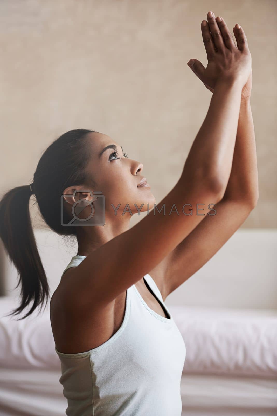 Royalty free image of Focus the mind, focus the body. a young woman doing yoga at home. by YuriArcurs