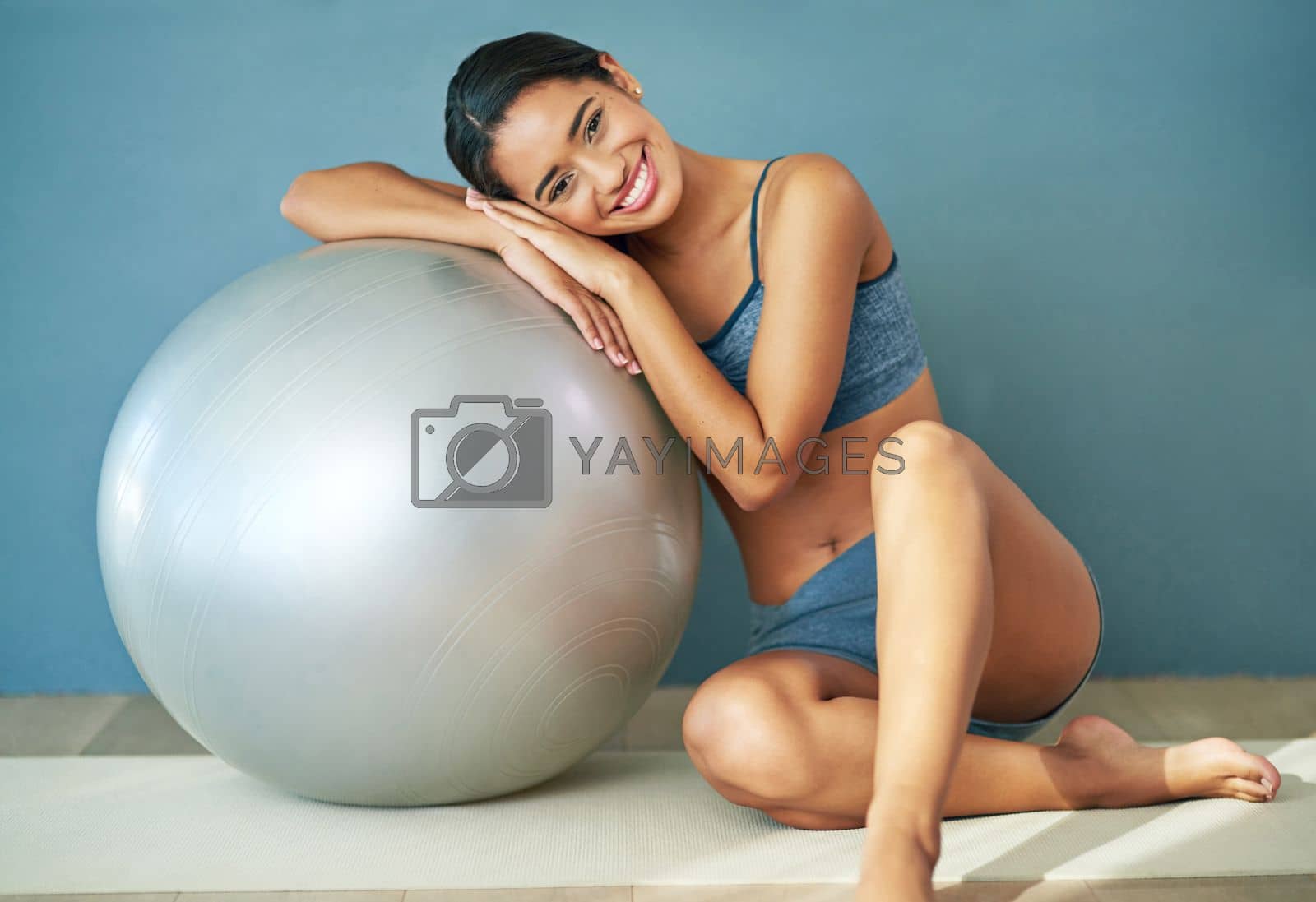 Royalty free image of Everyday is a good day to workout. a sporty young woman leaning against a pilates ball. by YuriArcurs