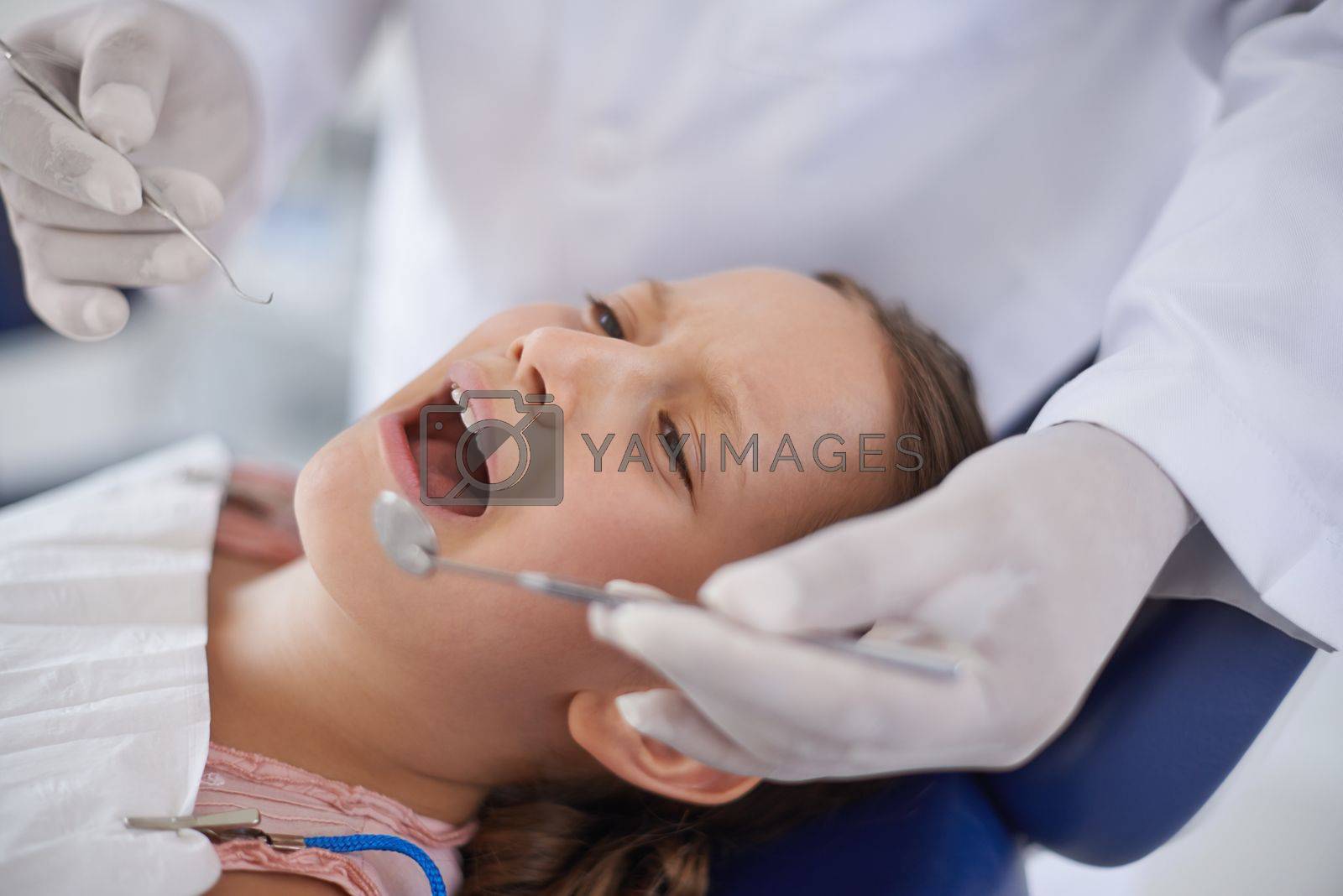 Royalty free image of At the dentist for her regular check-up. A young girl at the dentist for a check-up. by YuriArcurs
