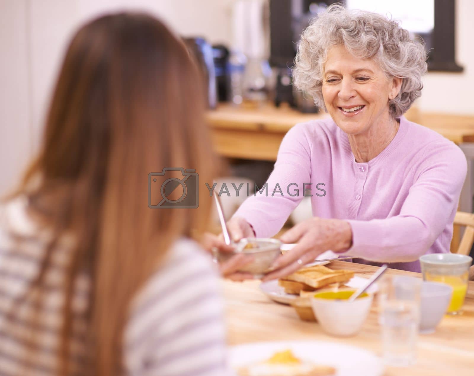 Royalty free image of Sharing a meal. a family eating breakfast around the kitchen table. by YuriArcurs