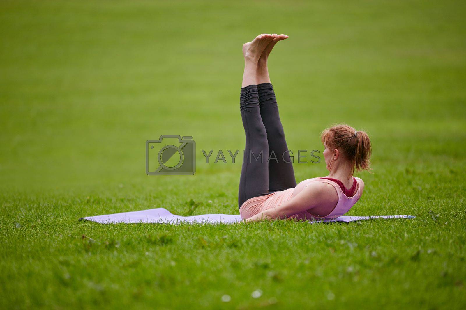 Royalty free image of The perfect yoga studio. a woman doing yoga in the park. by YuriArcurs
