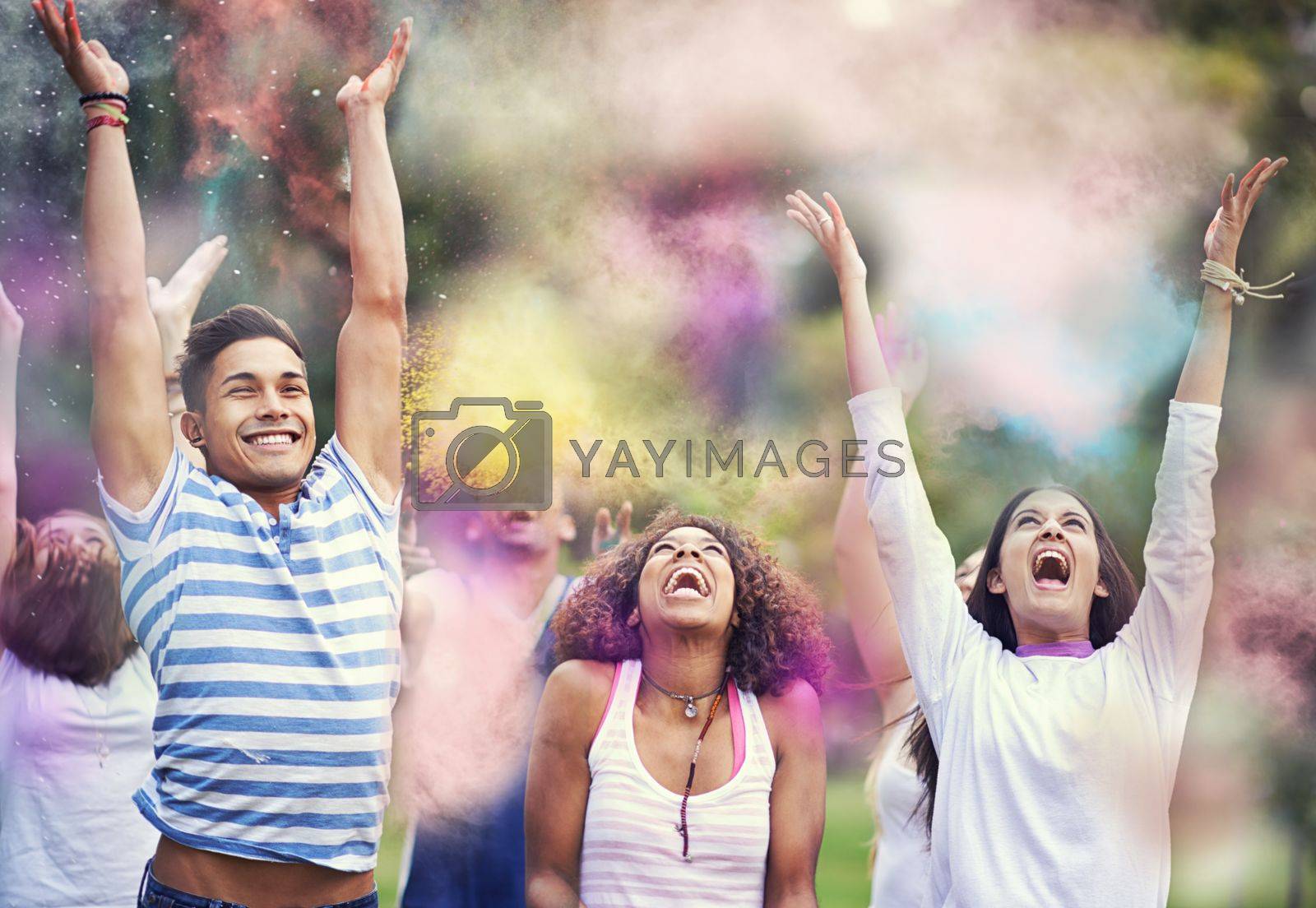 Royalty free image of Chasing the rainbow. happy friends having fun with powder paint. by YuriArcurs