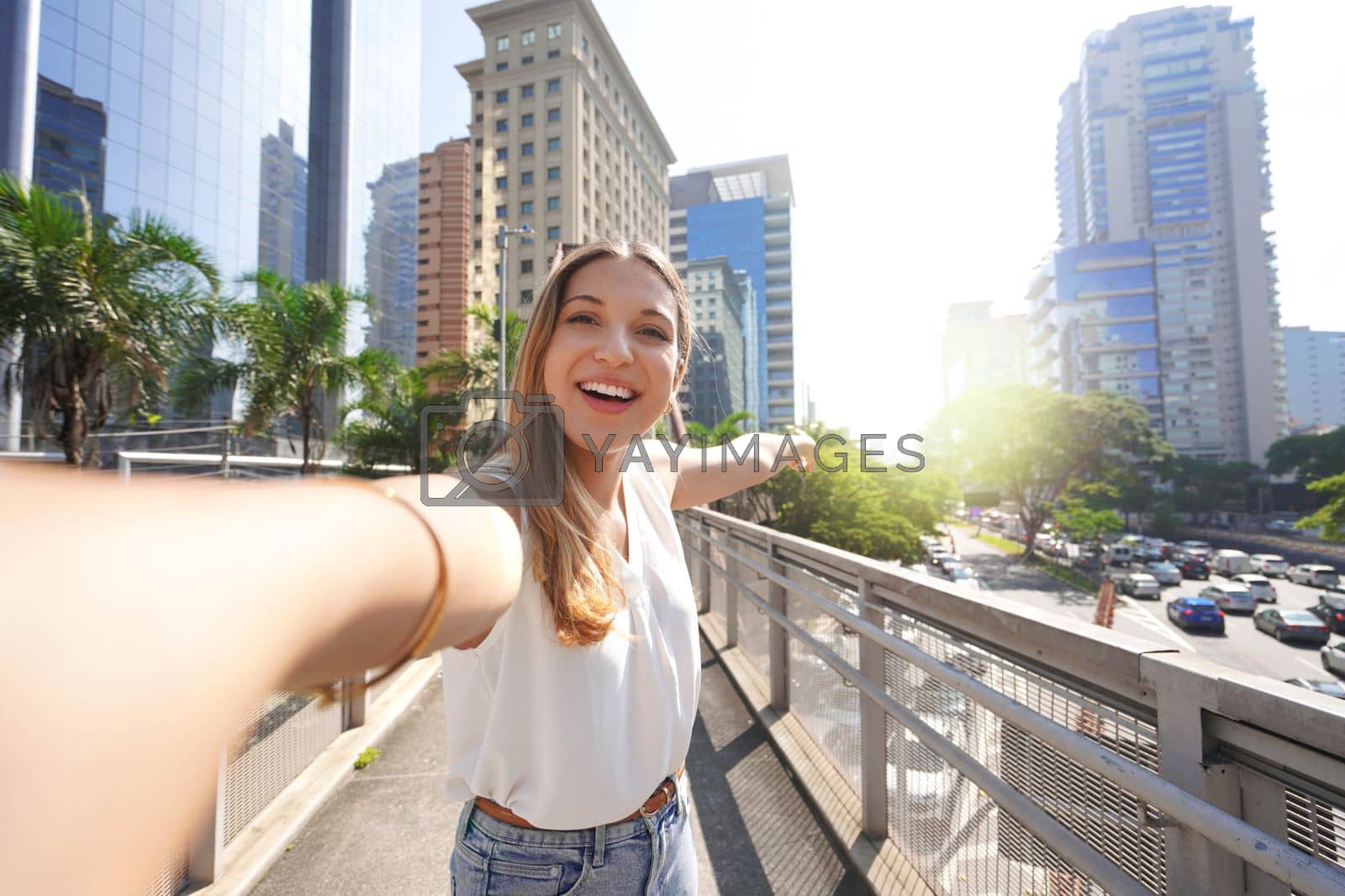 Royalty free image of Travel in Sao Paulo, Brazil. Beautiful smiling girl takes self portrait in Sao Paulo sustainable metropolis, Brazil. by sergio_monti