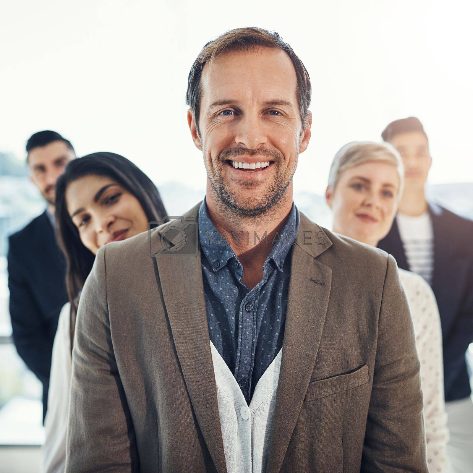 Royalty free image of Backed by the best for sure. Portrait of a diverse group of businesspeople standing in a line in an office. by YuriArcurs